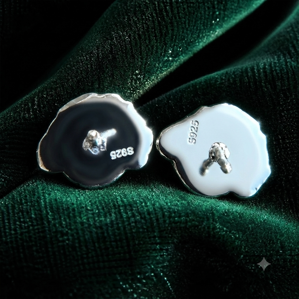 Back detail of sterling silver S925 pet portrait stud earrings on emerald velvet