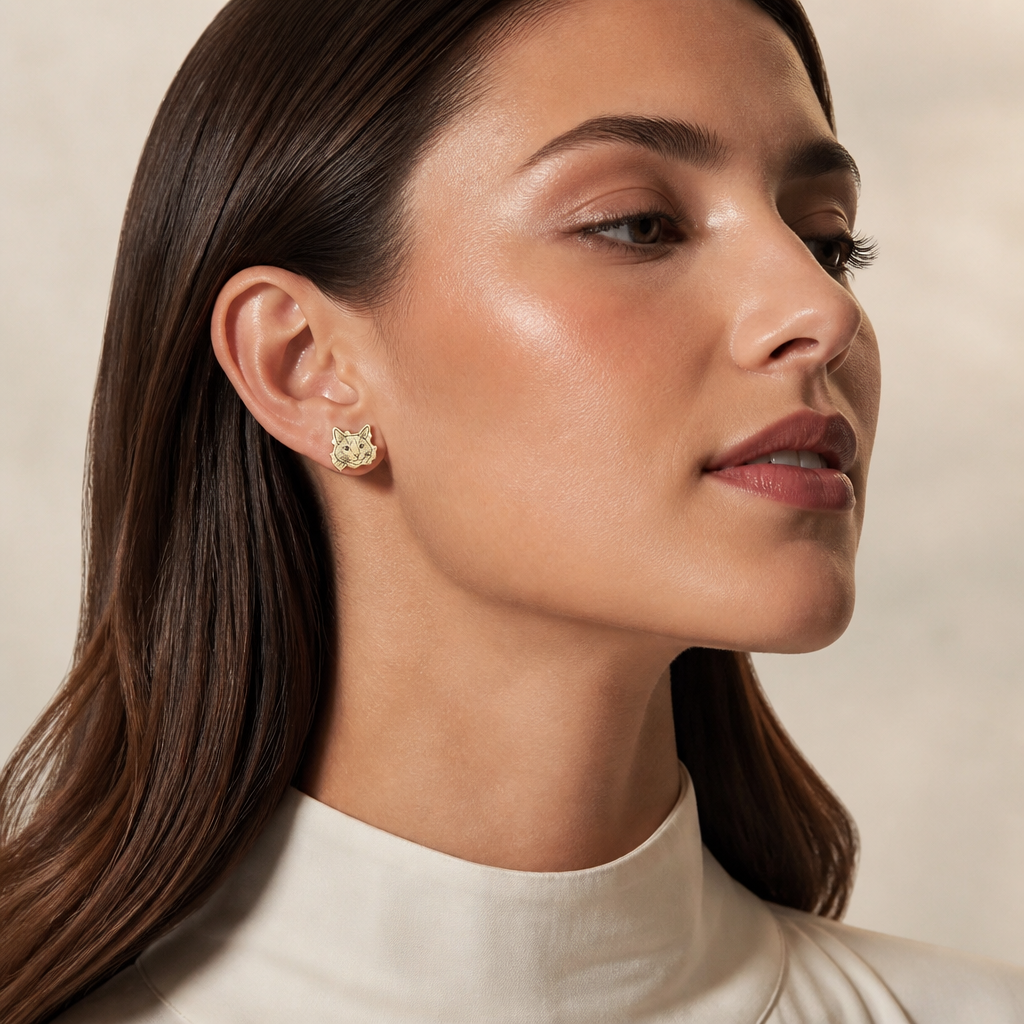 Model wearing gold cat portrait stud earring
