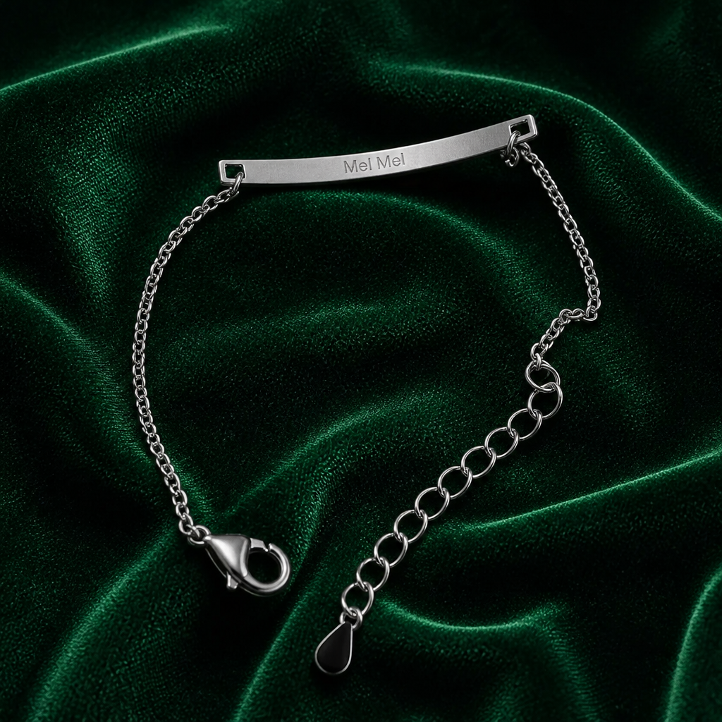 Sterling silver bar bracelet engraved with pet name on emerald velvet